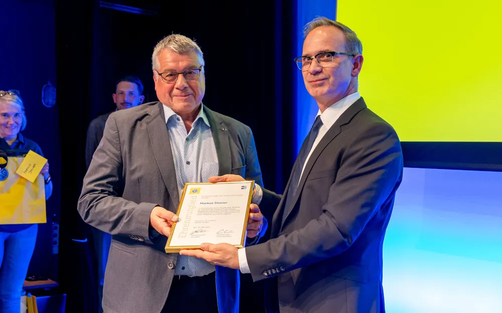 Patrick Gosteli überreicht dem ehemaligen Präsidenten des Camping Club Aargau, Markus Steiner, die Ehrenmitglied-Urkunde.
